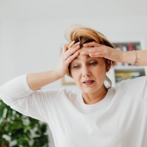 Photo of am overwhelmed woman wearing a white sweater
